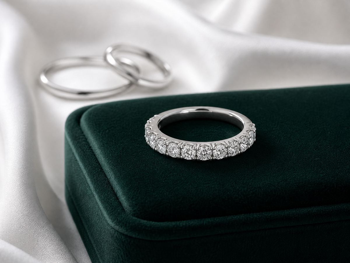 Elegant diamond anniversary ring in platinum with emerald velvet and white silk